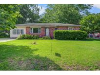 Charming single-story brick home with a well-maintained lawn and mature trees at 2903 Shadow Ln, North Charleston, SC 29406