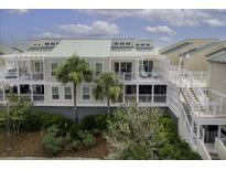 Inviting multi-story condo with private balconies, palm trees, and lush landscaping at 2942 Atrium Villa Dr # 42, Johns Island, SC 29455