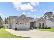 Charming single-story home with a well-maintained lawn and an attached garage at 3473 Plow Ground Rd, Johns Island, SC 29455
