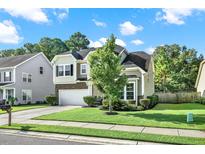 Charming two-story home featuring a well-manicured lawn and inviting curb appeal at 466 Gianna Ln, Goose Creek, SC 29445