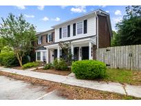 Charming townhome featuring a classic brick and siding facade with well-maintained landscaping at 655 Swinton Ct, Mount Pleasant, SC 29464