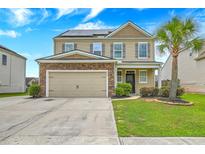 Charming two-story home featuring a stone-accented garage, solar panels, a manicured lawn and a palm tree at 7675 High Maple Cir, North Charleston, SC 29418
