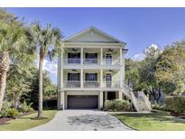 Inviting, two-story home with double porches, lush landscaping, and a convenient two-car garage at 828 Bridge Point Cir, Mount Pleasant, SC 29464