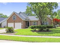 Charming brick home with two-car garage, well-manicured lawn, and mature tree in a lush neighborhood at 106 Chedburg Dr, Goose Creek, SC 29445
