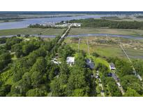 Stunning aerial view of the home featuring lush green landscape and proximity to the water and a creek at 1193 River Rd, Johns Island, SC 29455