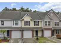 Attractive multi-level townhome with neutral siding, covered entry, and attached garage at 163 Darcy Ave, Goose Creek, SC 29445