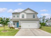 Charming two-story home featuring gray siding, a two-car garage, and a well-manicured front yard at 209 Parkwood Vista Way, Summerville, SC 29486