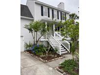 Charming two-story home with landscaped yard, white stairs, and inviting front porch at 324 Wild Horse Ln, Mount Pleasant, SC 29464
