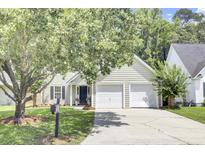 Charming home featuring a two-car garage, black shutters, and a well-manicured lawn at 350 Arlington Dr, Charleston, SC 29414