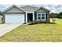 Charming single-story home with brick accents, a two-car garage, and a well-manicured lawn at 505 Shady Maple St, Moncks Corner, SC 29461