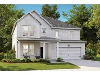 Charming two-story home with white siding, a welcoming front porch, and an attached two-car garage at 535 Verdi Dr, Summerville, SC 29486