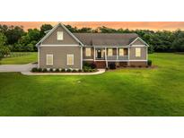 Charming home featuring a cozy front porch and well-manicured lawn at 727 Sonny Boy Ln, Johns Island, SC 29455