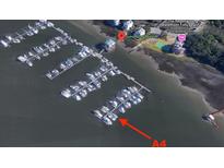 An aerial view of a marina and boat docks with boats, next to waterfront homes with private boat access at We 10Th St # A4, Folly Beach, SC 29439