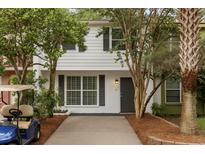 Charming two-story home with well-maintained landscaping and a gray front door at 11 America St, Charleston, SC 29403