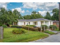 Charming ranch-style home with light-colored siding, mature landscaping, and a well-maintained front yard at 1121 Armstrong Ave, Charleston, SC 29407