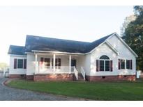 Charming single-story home featuring a welcoming front porch, red shutters and a well-maintained lawn at 154 Patrick Ln, Summerville, SC 29483