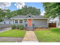 Charming single-story home with a landscaped front yard and a welcoming pink front door at 4587 Durant Ave, North Charleston, SC 29405