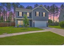 Charming two-story home with a well-manicured lawn and attached two car garage at 504 Sarno Way, Summerville, SC 29486
