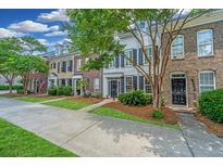 Charming row of townhouses with brick and siding exteriors, and well-maintained landscaping at 765 Certificate Ct, Charleston, SC 29414