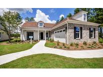 Charming single-story home featuring manicured lawn, a walkway and a mix of brick and siding exterior elements at 113 Magnolia House Dr, Summerville, SC 29486