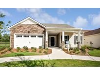 Charming single-story home featuring a stone facade, attached garage, and well-maintained landscaping at 120 Magnolia House Dr, Summerville, SC 29486