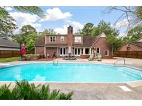 Backyard featuring a large in-ground pool and ample deck space for lounging and outdoor entertaining at 129 Dunbury Dr, Summerville, SC 29485