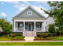 Charming two-story home featuring a welcoming front porch and beautifully landscaped yard at 1517 Willtown St, Charleston, SC 29492