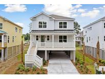 Charming two-story home with a inviting front porch and ample parking underneath the house at 1655 Cultivation Ln, Mount Pleasant, SC 29466