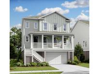 Charming two-story home featuring a covered porch, white trim, and lush landscaping at 1754 Cultivation Ln # 513, Mount Pleasant, SC 29466