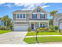 Charming two-story home featuring manicured lawn, attached garage, and inviting front porch at 207 Center Hill Ct, Summerville, SC 29485