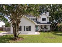 Charming two-story home with a welcoming front porch and beautiful lawn at 237 Dillard Dr, Goose Creek, SC 29445