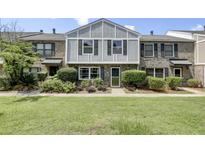Charming two-story brick townhouse with a well-manicured lawn and lush landscaping at 2906 Cathedral Ln, Charleston, SC 29414