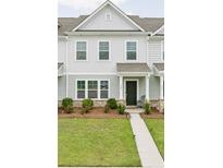 Charming townhome with a well-manicured lawn and covered front porch at 328 Surfbird Rd, Summerville, SC 29486