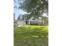 Charming one-story home featuring an attached garage and a lush green lawn with a tree swing for outdoor enjoyment at 340 Mount Royall Dr, Mount Pleasant, SC 29464