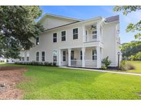 Charming two-story home with a welcoming front porch and a well-maintained lawn at 428 Bluegill Ln, Johns Island, SC 29455