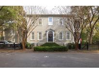 Inviting two-story home with a black metal fence, complemented by a manicured front garden at 74 Hospitality St, Mount Pleasant, SC 29464