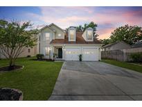 Charming two-story home featuring a well-manicured lawn, two-car garage, and inviting curb appeal at 8340 Coventry Ct, North Charleston, SC 29420