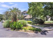 Charming townhouse with mature landscaping, including palms and lush greenery, enhancing its curb appeal at 1120 Hidden Cove Dr # I, Mount Pleasant, SC 29464
