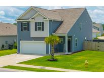 Charming two-story home with a well-manicured lawn and attached two-car garage at 118 Lagoona Dr, Summerville, SC 29483