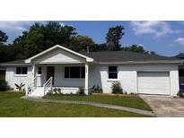 Charming single-story home with a well-manicured lawn and attached garage at 1229 Winston St, Charleston, SC 29407