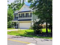 Charming two-story home boasts manicured lawn, attached garage and lovely curb appeal at 133 Pelican Lane, Summerville, SC 29485