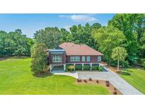Stunning home on sprawling green lawn with mature landscaping, and convenient drive under parking at 1343 Headquarters Plantation Dr, Johns Island, SC 29455
