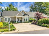 Charming single-story home with a well-manicured lawn and inviting curb appeal under a beautiful blue sky at 2438 Hansard Dr, North Charleston, SC 29406