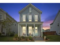 Charming two-story home featuring a cozy front porch with seating, a welcoming entrance and manicured landscaping at 330 Ripple Park Dr, Summerville, SC 29486