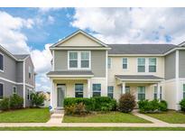 Charming two-story townhome showcasing neat landscaping and inviting curb appeal on a sunny day at 3927 Four Poles Park Dr, North Charleston, SC 29405