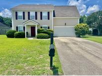 Charming two-story home with a well-manicured lawn and traditional curb appeal at 412 Beverly Dr, Summerville, SC 29485