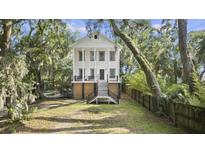 Charming two-story home with a spacious yard and beautiful mature trees at 4601 Apple St, North Charleston, SC 29405