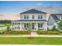Charming two-story home featuring a spacious front porch and beautifully landscaped front yard at 501 Rhythm St, Summerville, SC 29486