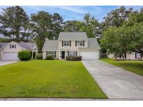 Charming two-story home with well-manicured front yard and inviting curb appeal at 633 Alwyn Blvd, Summerville, SC 29485
