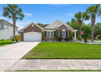 Charming brick home with an attached garage, well manicured lawn, and stately palm trees at 7030 Billberry St, Hanahan, SC 29410